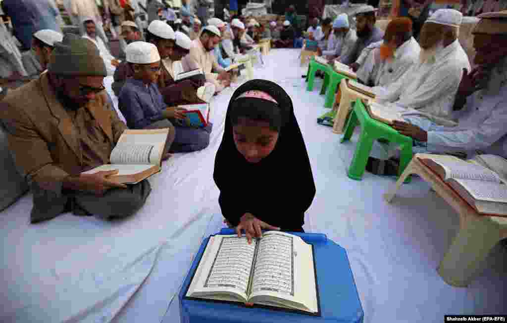 Muslims read the holy Koran during a protest against its desecration by Lars Thorson, the leader of Norway&#39;s Stop Islamization of Norway (SIAN), during a protest in Karachi, Pakistan, on November 28. (epa-EFE/Shahzaib Akber)