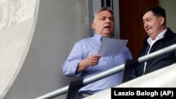 The police summons concerns drone footage of a business owned by Lorinc Meszaros (right), a billionaire friend of Hungarian Prime Minister Viktor Orban (left).