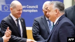 Germany's Chancellor Olaf Scholz (left) shakes hands with Hungary's Prime Minister Viktor Orban in Brussels on February 1.