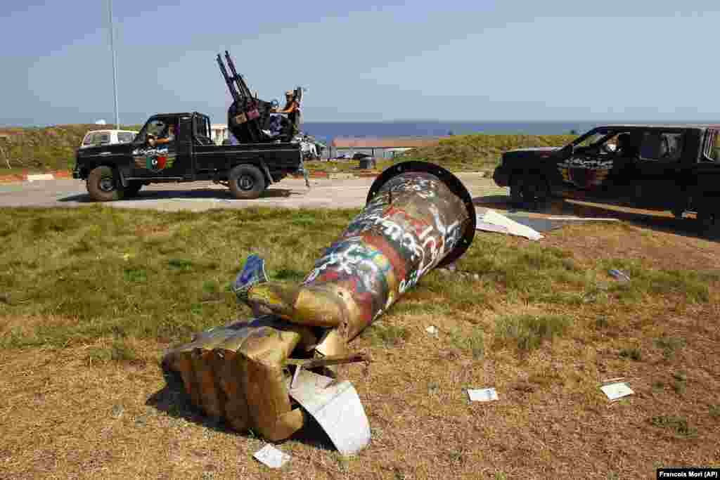 The graffiti-covered monument of a fist depicted crushing a U.S. fighter jet that once stood in Tripoli, Libya. The famous sculpture was toppled during the 2011 civil war and is now reportedly in a Libyan museum.