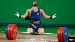 Kianoush Rostami of Iran reacts after setting a new Olympic record during the 2016 Olympic Games in Rio de Janeiro in August 2016.