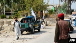 Members of the Taliban at the site of an earlier blast in Jalalabad that took place on September 18