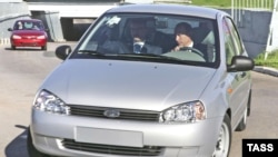 Russian President Vladimir Putin drives a Lada Kalina automobile while visiting the AvtoVAZ plant in Tolyatti in 2007.