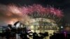 A massive fireworks display lights up the sky above the Sydney Opera House and the Sydney Harbour Bridge in Australia.