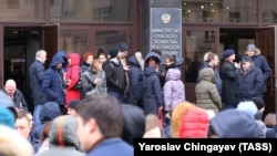 People are evacuated from the building of the Agriculture Ministry following an anonymous bomb threat in Moscow on February 5.