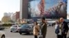 Iranian pedestrians cross a street at Valiasr square in Tehran, November 21, 2019