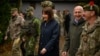 British Chancellor of the Exchequer Rachel Reeves (center) and Defense Secretary John Healey speak with soldiers and staff at a military facility in eastern England, where Ukrainian and U.K. troops are currently conducting training exercises.