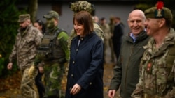 British Chancellor of the Exchequer Rachel Reeves (center) and Defense Secretary John Healey speak with soldiers and staff at a military facility in eastern England, where Ukrainian and U.K. troops are currently conducting training exercises.