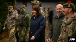 British Chancellor of the Exchequer Rachel Reeves (center) and Defense Secretary John Healey speak with soldiers and staff at a military facility in eastern England, where Ukrainian and U.K. troops are currently conducting training exercises.