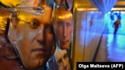 Masks of opposition leader Aleksei Navalny and President Vladimir Putin on sale at a souvenir stand in an underground passage in St. Petersburg.