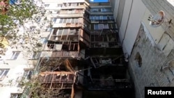 A view of a heavily damaged apartment building after what officials said was overnight Russian shelling in Kherson on August 7.