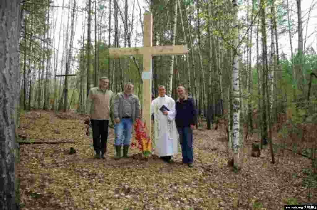 Ксёндз Вячаслаў Пялінак з памочнікамі ля магілы а. Адама Станкевіча