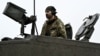 A Ukrainian soldier of the 82nd Separate Air Assault Brigade prepares for combat on a Challenger 2 tank in an undisclosed location near the front line in the Zaporizhzhya region on February 12.