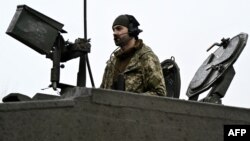 A Ukrainian soldier of the 82nd Separate Air Assault Brigade prepares for combat on a Challenger 2 tank in an undisclosed location near the front line in the Zaporizhzhya region on February 12.