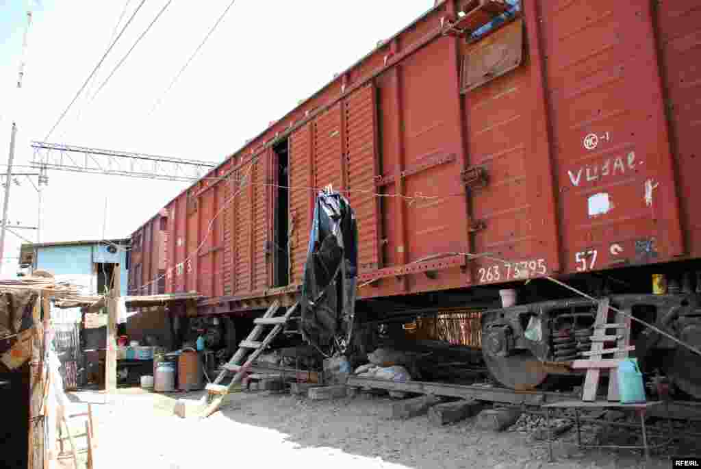 Azerbaijan - IMISHLI, Azerbaijan; August 24, 2007 (RFE/RL) -- For the past 14 years, abandoned cattle and freight cars sitting on decommissioned railway tracks in the town of Imishli, 250 kilometers southwest of Baku, have served as makeshift homes for hundreds of Azerbaijanis displaced by the Nagorno-Karabakh conflict. RFE/RL's Azerbaijani Service traveled to Imishli to look at conditions in the camp. 