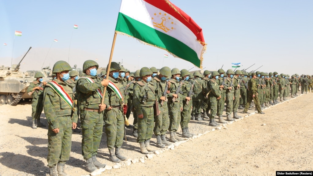 Members of Tajikistan's armed forces line up during joint military drills involving Russia, Uzbekistan, and Tajikistan at the Harb-Maidon training ground near the border with Afghanistan on August 10.
