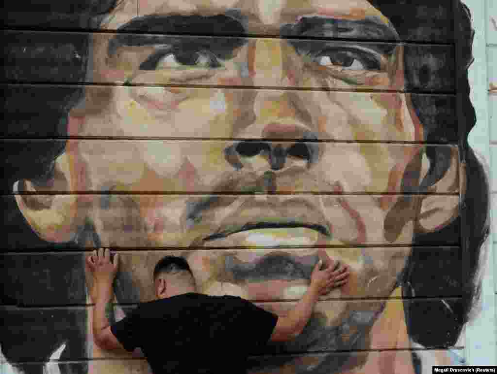 ბუენოს აირესში, გულშემატკივრები მარადონას სახელობის სტადიონთან იკრიბებიან და ლეგენდარული არგენტინელი ფეხბურთელი, დიეგო არმანდო მარადონას გარდაცვალებას გლოვობენ. მარადონა 25 ნოემბერს გულის შეტევით გარდაიცვალა. არგენტინის მთავრობამ ქვეყანაში 3-დღიანი გლოვა გამოაცხადა. 📷: REUTERS/Magali Druscovich