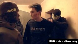 Russian Federal Security Service officers on December 30 detain a suspect who allegedly plotted acts of terror in St. Petersburg. 