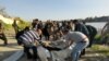 Rescue workers are seen near the site where the ferry sank in the Tigris River on March 21.