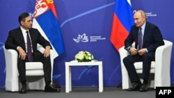 Serbian Deputy Prime Minister Aleksandar Vulin (left) and Russian President Vladimir Putin meet in Vladivostok on September 4.