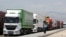 A man walks beside trucks waiting to cross into Iran from the Turkish side of the border near the Gurbulak border crossing between Turkey and Iran on June 27, 2012, at Dogubeyazit.