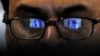 FILE: Facebook logo is reflected in the glasses of a Pakistani user.