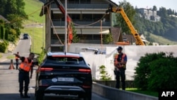 Police officers secure the access to the Burgenstock luxury hotel complex where US-Iran talks are expected.