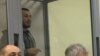 Akbarali Abdullaev speaks inside the defendant's cage as he attends a court hearing in Kyiv in February.