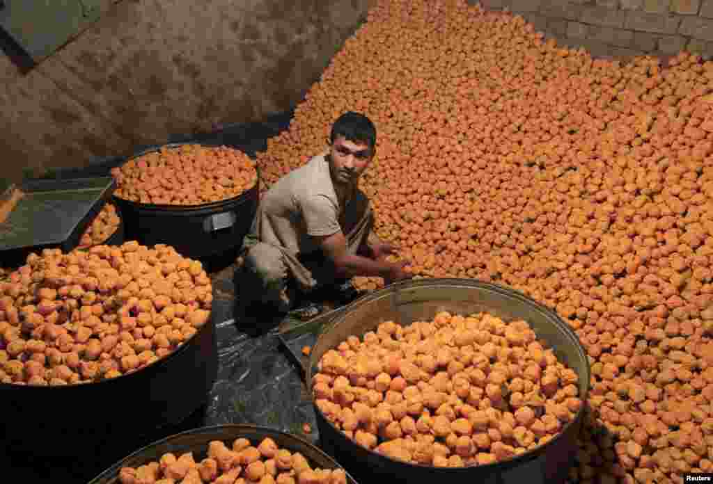 A vendor prepares special sweets for customers ahead of Eid al-Fitr, which marks the end of Ramadan, in Jalalabad on July 13. (Reuters/Parwiz)