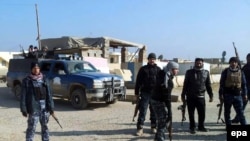 Gunmen walk the streets of the Iraqi city of Ramadi,which has been plagued by violence in recent weeks. 