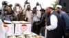 Hafiz Saeed (2-R), head of banned Islamic charity Jamat-ud-Dawa that now works with a new name Falah-e-Insaniyat Foundation, dispatch relief goods and cash funds for the victims of earthquake, at their relief good collection center in Islamabad on November 2.