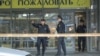 Belarusian police in a cordoned-off area at the Minsk shopping center where the deadly incident took place 