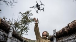 A Ukrainian serviceman launches a combat drone from his frontline position near the town of Pokrovsk in October. 