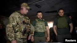 Ukrainians President Volodymyr Zelenskiy (center) visits members of his military's Special Operation Forces near Bakhmut on July 29. 