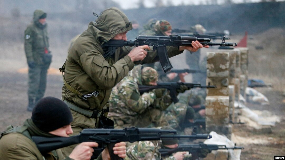 Militants of the self-proclaimed Donetsk People's Republic train at a range in Donetsk.