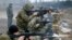 Militants of the self-proclaimed Donetsk People's Republic train at a range in Donetsk.