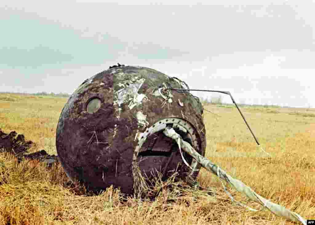 The charred descent capsule of Vostok 1 is seen at the landing site, 700 kilometers southeast of Moscow, on April 12, 1961. The capsule landed empty as Gagarin made a parachute jump at an altitude of 7,000 meters.