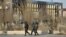 Interior Ministry troops patrol past partially burned buildings damaged in the December 16 unrest in the town of Zhanaozen three days after the clashes.