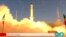 In this frame grab from Iran state TV video footage from June 26, an Iranian satellite-carrier rocket blasts off from an undisclosed location in Iran -- an event which drew a rebuke from Washington.
