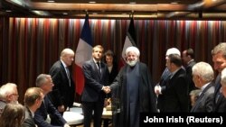 French President Emmanuel Macron shakes hands with Iranian President Hassan Rohani during their meeting on the sidelines of the United Nations General Assembly in New York, September 23, 2019