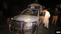 Pakistani police official inspect a vehicle after unknown assailants opened fire on the police vehicle in Quetta, the provincial capital of the restive Balochistan province on June 28.