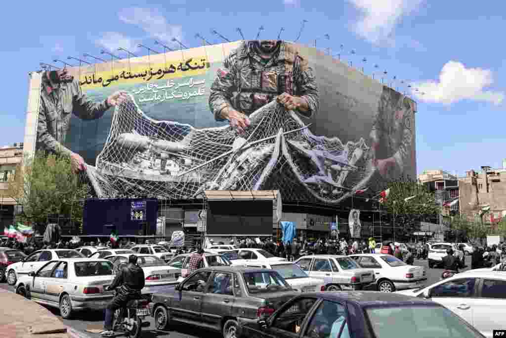 After the two-week cease-fire was announced, a large billboard remained on Tehran's Revolution Square reading "The Strait of Hormuz remains closed." Under the agreement, Iran was supposed to reopen the vital shipping route for global oil and gas exports from the Persian Gulf, but only a handful of vessels were getting through.