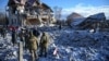 Residents and bomb squad members stand in front of a house destroyed by a Russian missile strike in Chernihiv, Ukraine, on January 4.