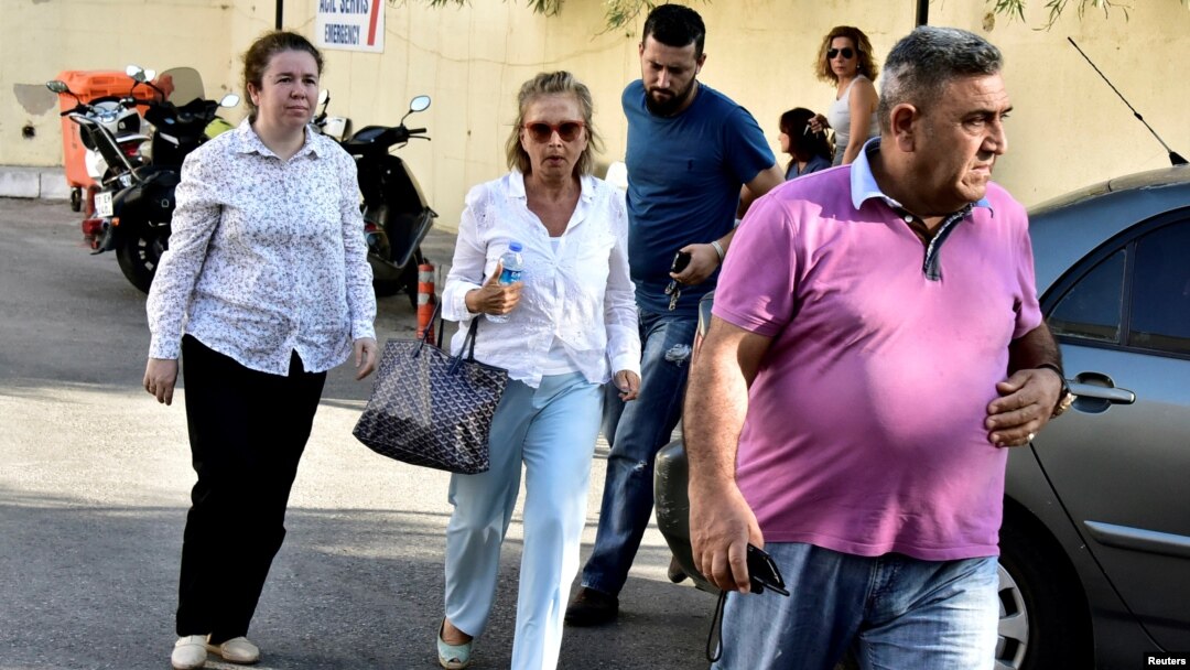 Turkish journalist Nazli Ilicak (center), a well-known commentator and former parliament deputy, is escorted by a police officer and relatives after being detained in Bodrum days after the failed coup in Turkey on July 15. 