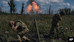 Ukrainian soldiers fire a mortar toward Russian positions at the front line near Bakhmut on August 12.