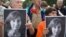 People hold portraits of journalist and human rights activist Natalya Estemirova during a rally in Moscow in July 2009. 
