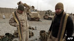 FILE: U.S. Marines check their gear at a company operation base (COB) in Helmand Province.