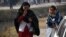 Distraught parents whose children are trapped in the school arrive close to the school following an attack at the Army run school in Peshawar on December 16.