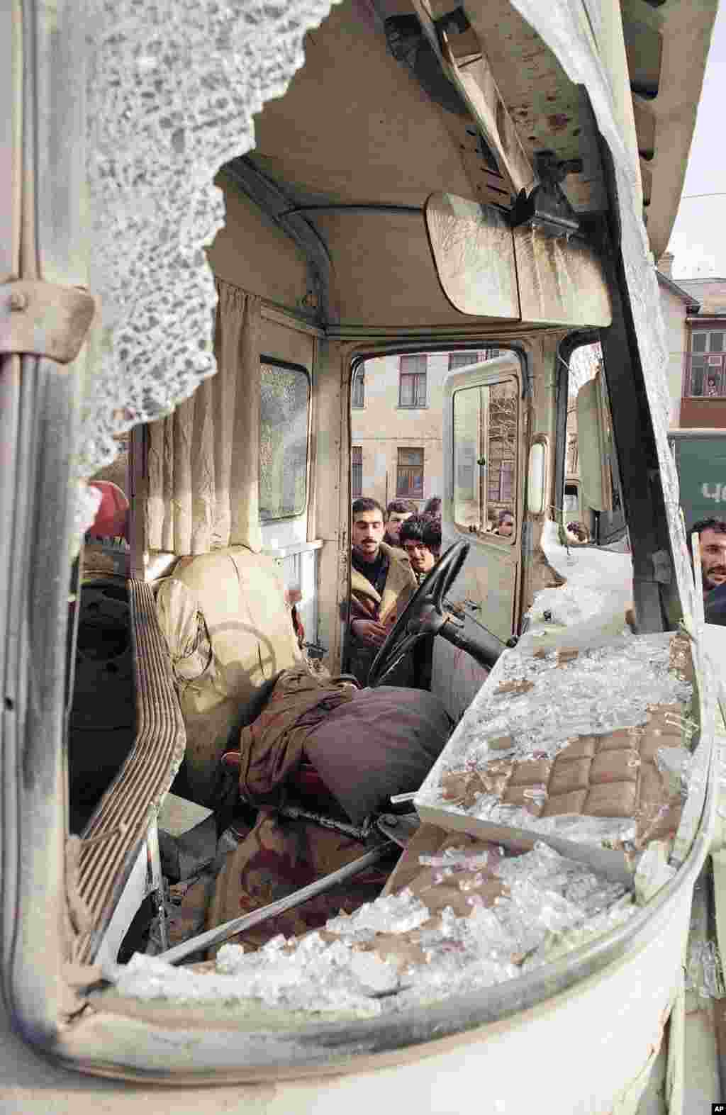 Baku residents inspect a bus that was shot up by Soviet troops on January 21.