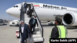 Passengers disembark an Iranian Mahan Air flight at the airport in Kabul on September 15.